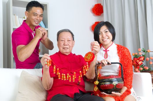 Asian senior man and children celebrating chinese new year