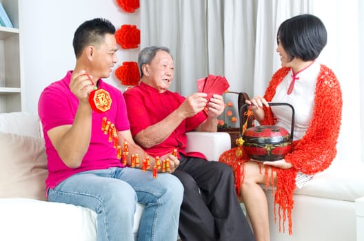 Asian senior man and children celebrating chinese new year