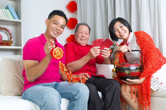 Asian senior man and children celebrating chinese new year