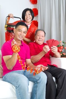 Asian senior man and children celebrating chinese new year