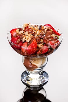 Slices of chocolate in a glass on a glass background