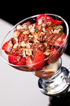 Slices of chocolate in a glass on a glass background