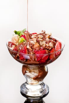 Slices of chocolate in a glass on a glass background