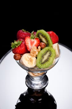 Slices of chocolate in a glass on a glass background