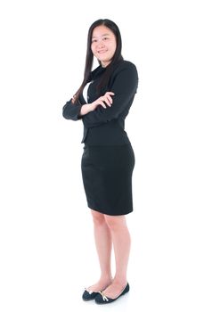 Full body Asian business woman standing on plain background.