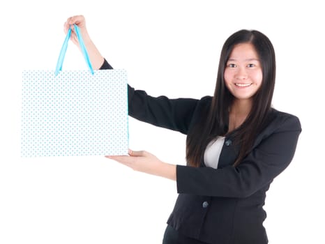 Shopping woman holding shopping bags looking at camera on white background. Beautiful young Asian shopper smiling happy.