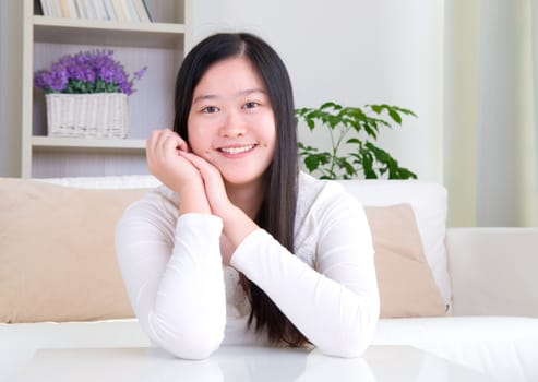 Portrait of attractive Asian girl smiling. Young woman indoors living lifestyle at home.