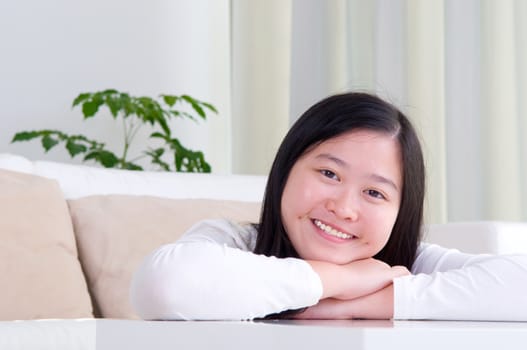 Portrait of attractive Asian girl smiling. Young woman indoors living lifestyle at home.