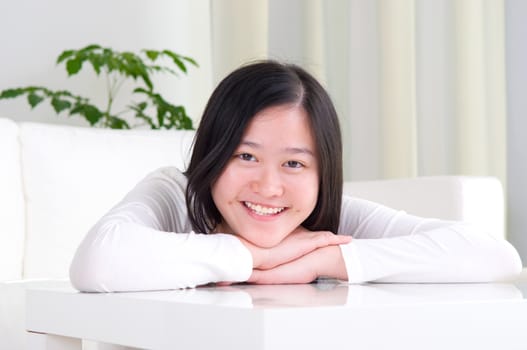 Portrait of attractive Asian girl smiling. Young woman indoors living lifestyle at home.