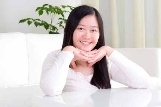 Portrait of attractive Asian girl smiling. Young woman indoors living lifestyle at home.