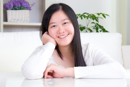 Portrait of attractive Asian girl smiling. Young woman indoors living lifestyle at home.