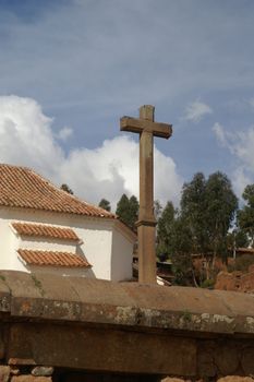 Spanish cross and Inca ruins - peruvian cultural heritage in Ands, Chinchero, Peru