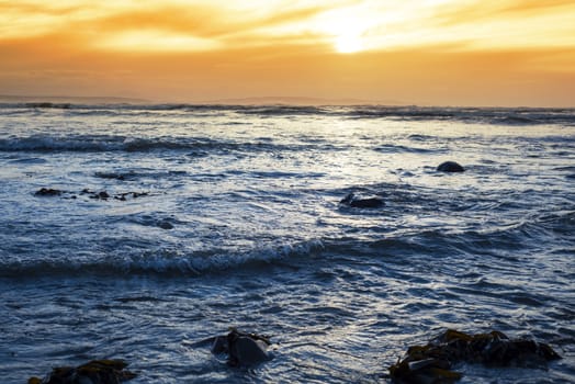 rocky beal beach near ballybunion on the wild atlantic way ireland with a beautiful yellow sunset