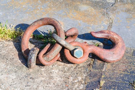 Mooring strap, steel hook and eye at a quay for securing larger motor ships.