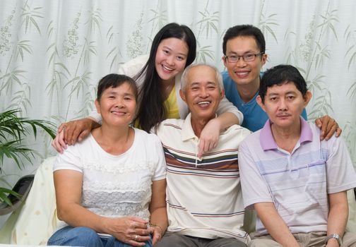 Asian parent with their adult sons and daughter at home. Family living lifestyle.