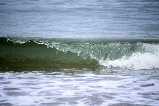 crisp green waves lashing onto ballybunion beach in county kerry ireland