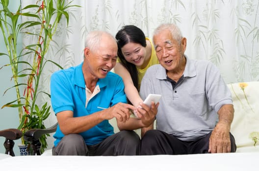 Modern technology, age and people concept. Asian family using smart-phone, self photographing. Family living lifestyle at home.