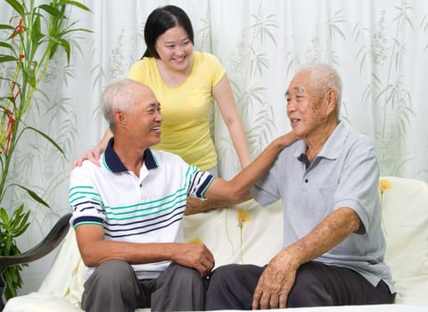 Asian senior father with his adult son and granddaughter at home. Family living lifestyle.