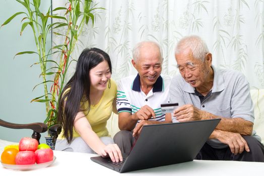 Asian senior man learns to use online internet banking
