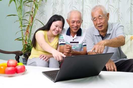 Asian senior man learns to use online internet banking