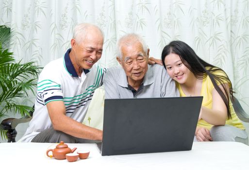 Asian senior man learns to use tablet computer