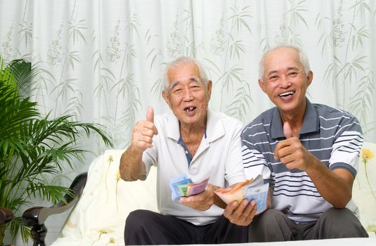 Asian senior man and children calculating money at their home