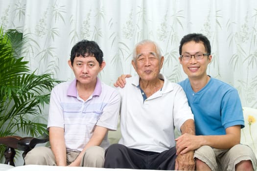 Asian senior father with his adult sons at home. Family living lifestyle.