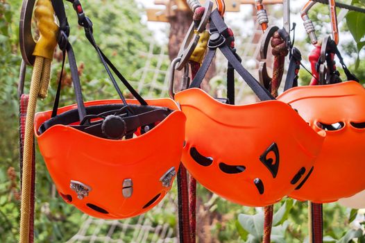 orange helmet hanging on for skalalazaniya carabiner and rope park 