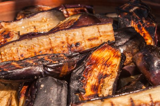 In length the eggplants cut by slices were fried thoroughly well on pieces of coal