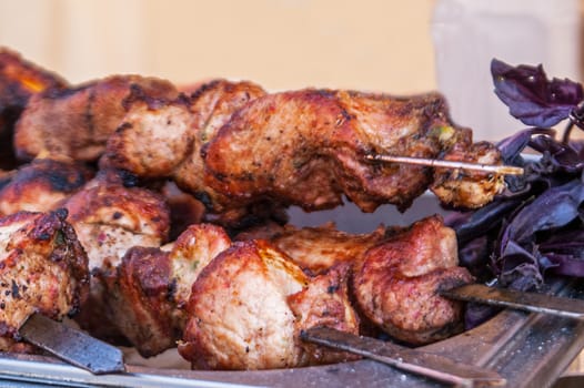 some juicy skewers of the fried meat a grill with a basil