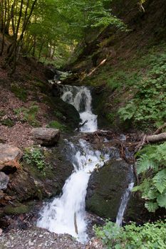 Waterfall in French alps  hiking attraction in a forest