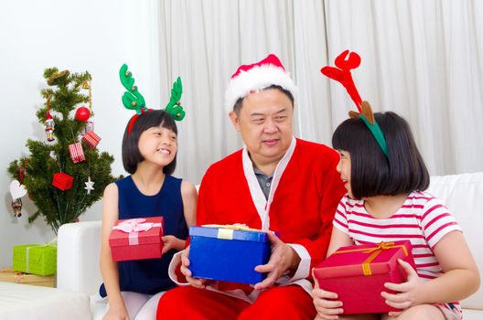 Portrait of happy family members in Santa caps on Christmas eve