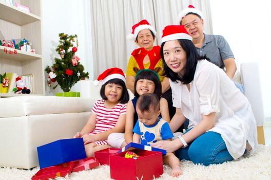 Portrait of happy family members in Santa caps on Christmas eve