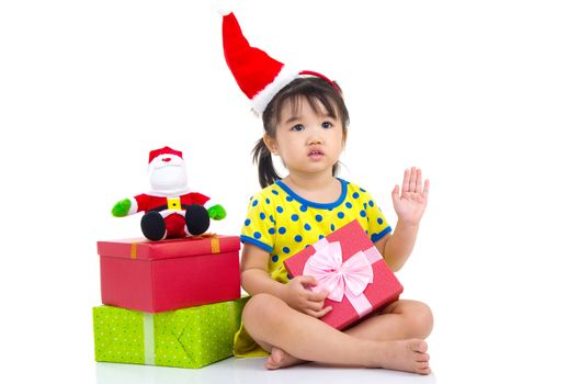 Little Asian girl in Santa hat and Christmas gift box isolated on white