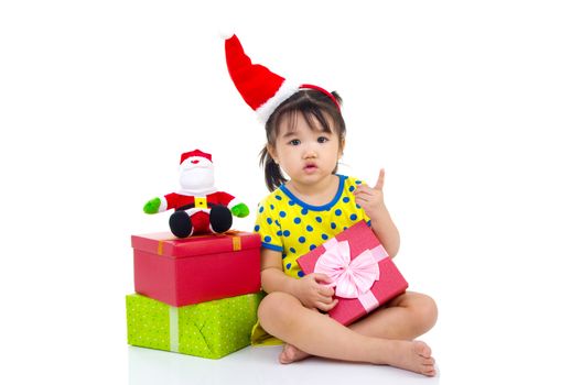 Little Asian girl in Santa hat and Christmas gift box isolated on white