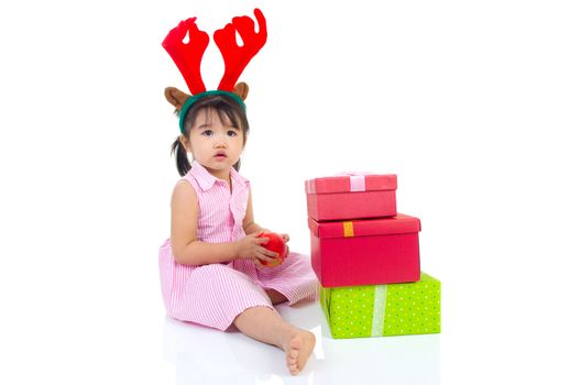 lovely asian girl holding an apple and enjoying christmas gift box