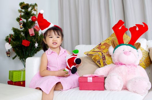 Portrait of happy asian kid in Santa caps on Christmas eve
