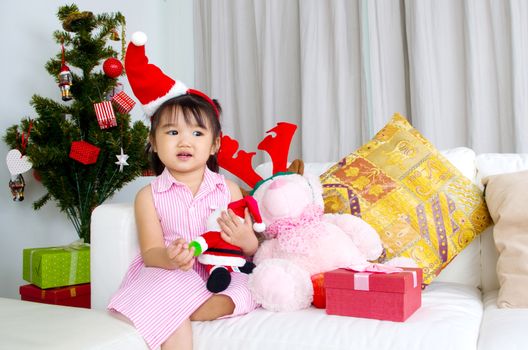 Portrait of happy asian kid in Santa caps on Christmas eve