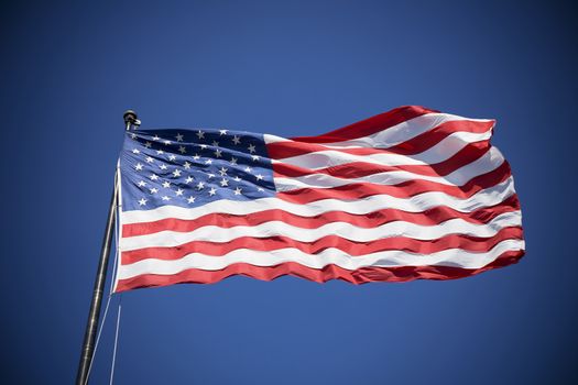 American flag on the blue sky, USA, special photographic processing.