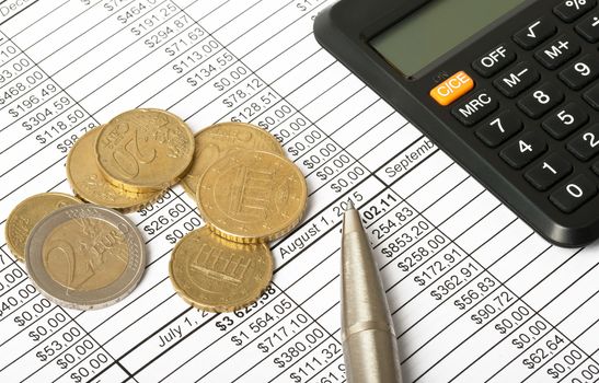 Calculator with coins and pen on bills background, closeup