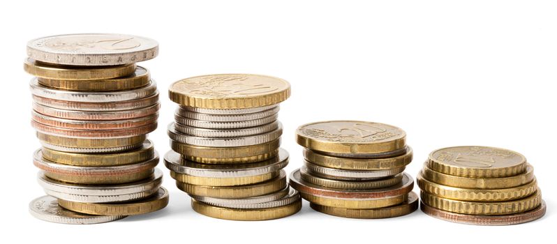 Four stacks of gold coins isolated on white background, closeup