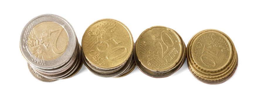 Four stacks of coins isolated on white background, closeup