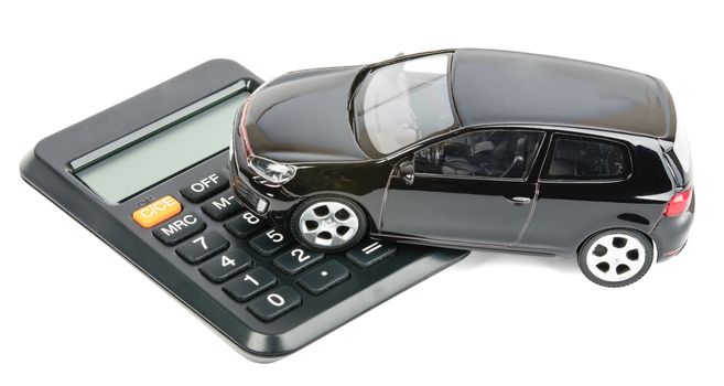 Car on calculator isolated on white background