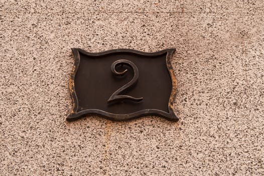 The metal plate with the house number 2