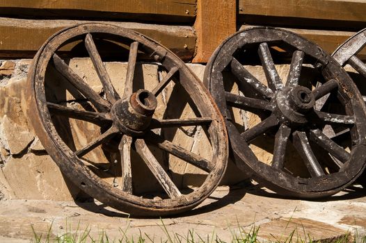 old wooden wheel standing near the house