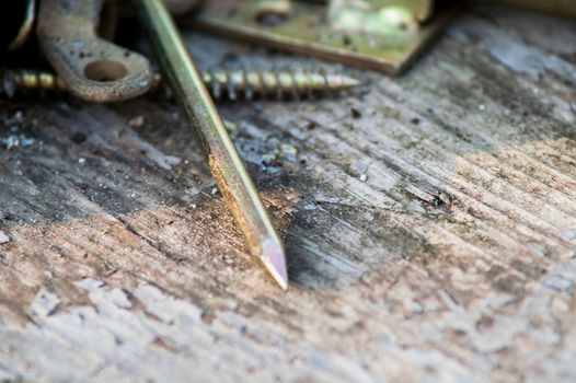 Lying metal nails close-up on a wooden table