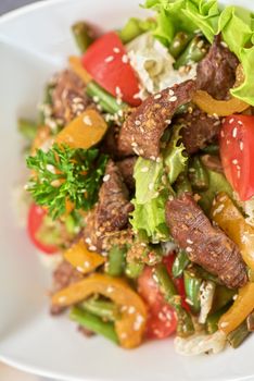 Warm salad with veal closeup