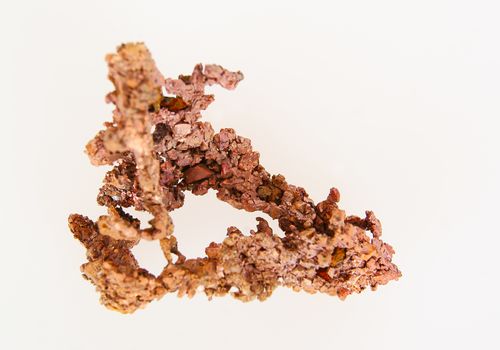 Piece of native shapeless copper on white background