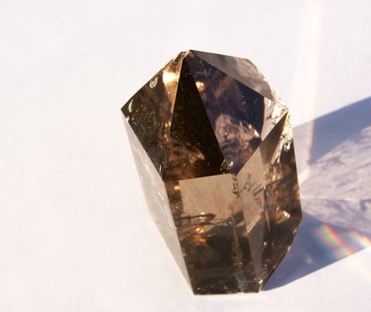 A Smoky Quartz Crystal in natural sunlight with a rainbow from Hallelujah Junction NV USA