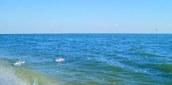 Pair of white flip-flops floating in the ocean